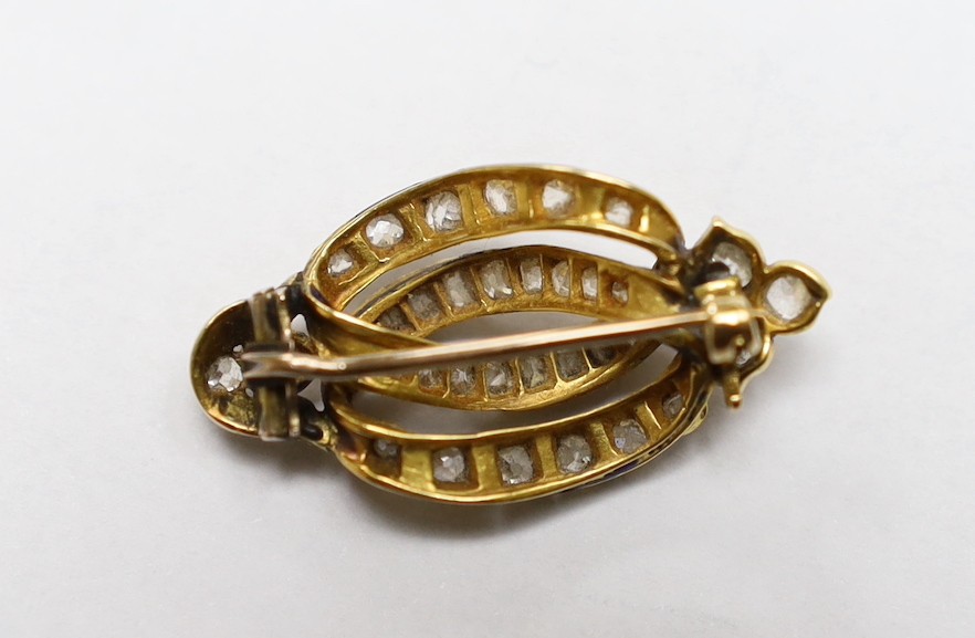 A late Victorian diamond set gold scroll brooch, 3.25cm, gross 5.8 grams